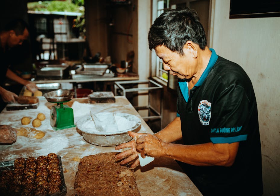Asian man preparing bread dough in a rustic bakery in Kon Tum, Vietnam.