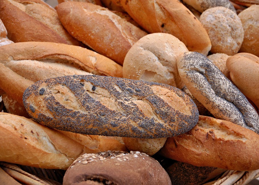 Close-up of a basket filled with assorted freshly baked artisan breads including seeded varieties.